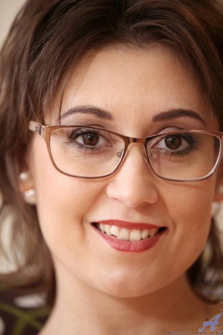 Czech MILF with glasses Meggie Marika rubs her hairy clit as she strips naked