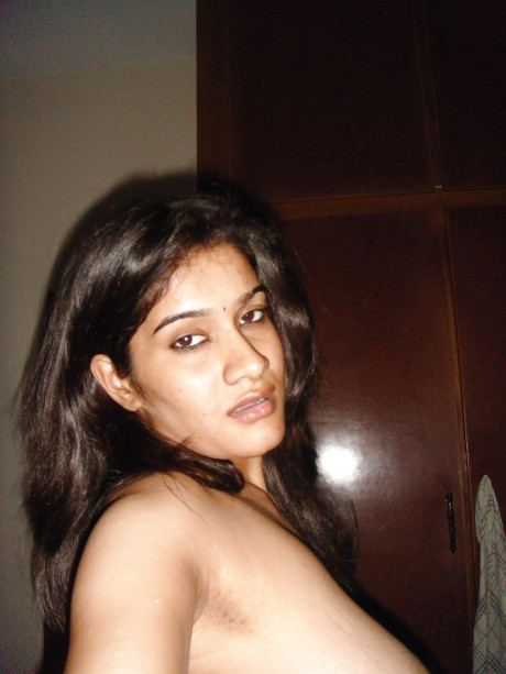 Indian solo chick GF chick sucks on the nipples of her massive naturals during self shots