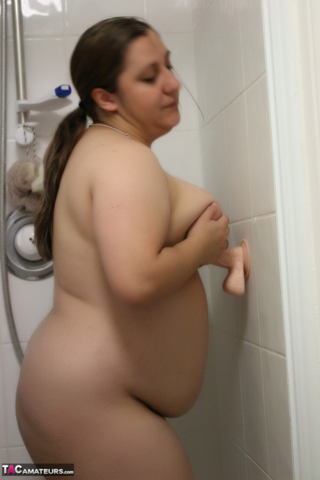 Meaty amateur Kimberly Scott licks and tit rides a suction dildo in the shower