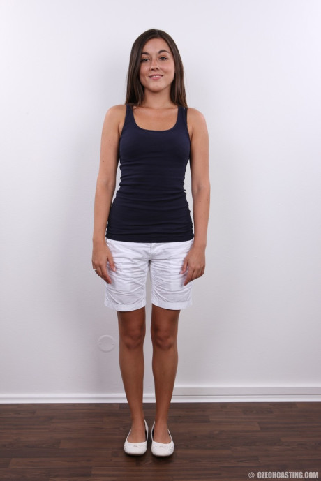 Cute teen stands nude after removing her clothes and underthings
