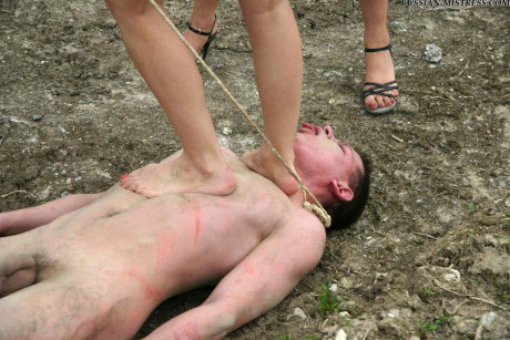 Cruel women trample and piss a submissive man man stud during outdoor CFNM play