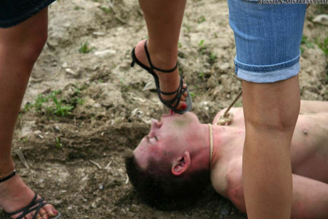 Cruel women trample and piss a submissive man man stud during outdoor CFNM play