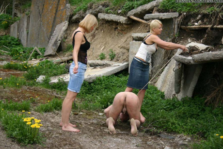 Cruel women trample and piss a submissive man man stud during outdoor CFNM play