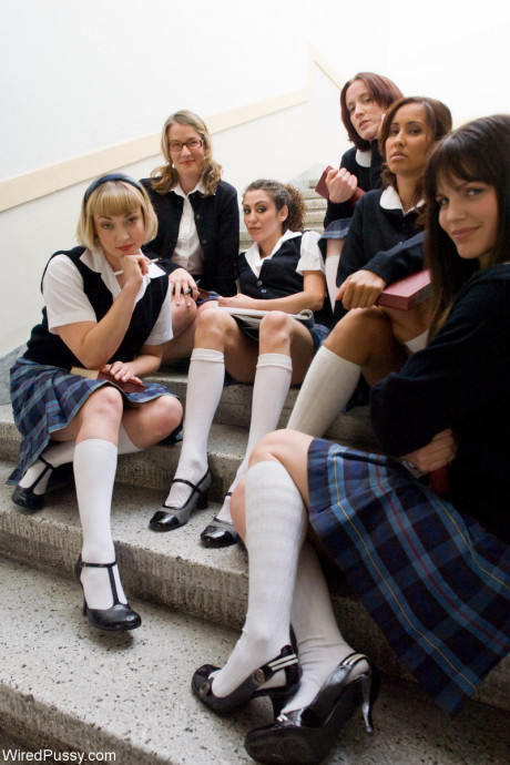 Redheaded teacher with enormous boobies Kylie Ireland spanks a hot schoolgirl
