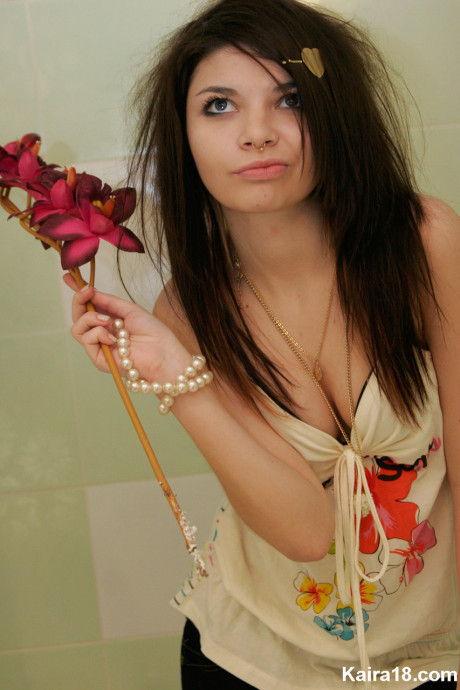 Tiny teen Kaira 18 scrunches up her face during a non undressed shoot in a bathroom