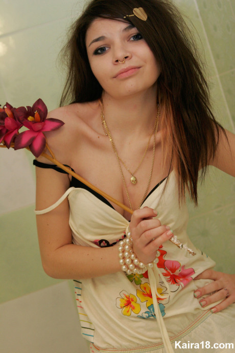 Tiny teen Kaira 18 scrunches up her face during a non undressed shoot in a bathroom