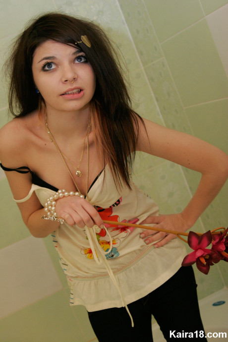 Tiny teen Kaira 18 scrunches up her face during a non undressed shoot in a bathroom