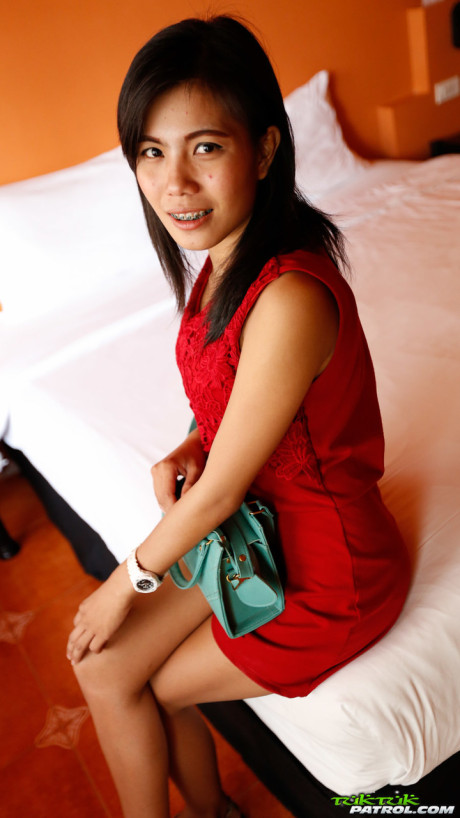 Lovely oriental Wan shows off her thin body while undressing for sex