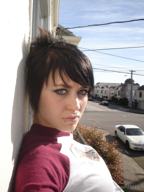 Short-haired punk bitch chick with pierced nose, lip, navel in her own photos