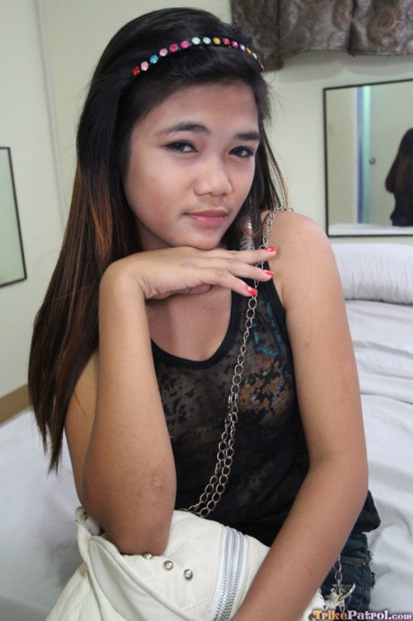 Brunette Filipina Mildred strips and shows off her bushy twat