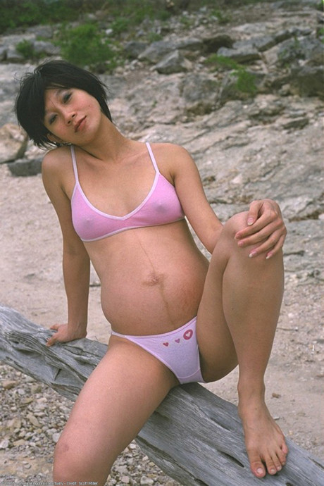 Pregnant Japanese teenie Miho strips in nature and shows her super furry pussy
