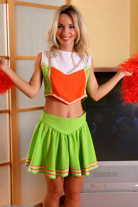 Thin cheerleader Natalia takes off her uniform & spreads her bushy twat