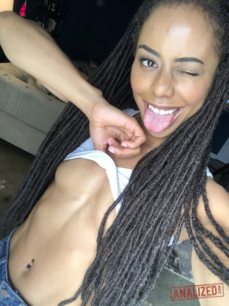 Ravishing black teen Kira Noir reveals her hot behind and tiny boobies in a solo