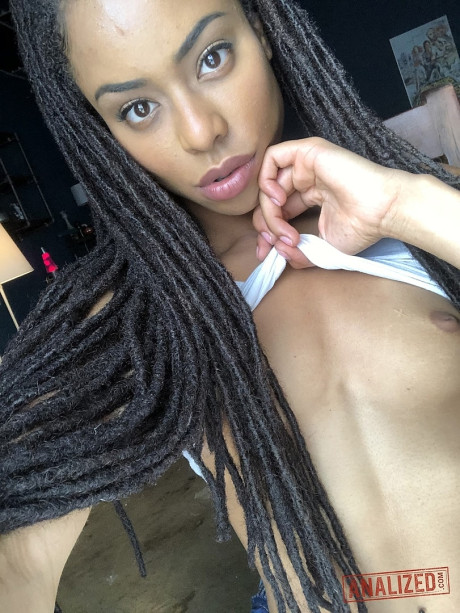 Ravishing black teen Kira Noir reveals her hot behind and tiny boobies in a solo