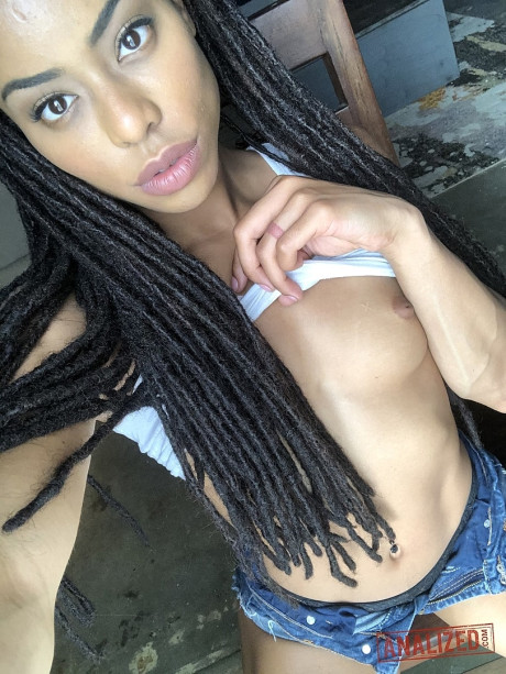 Ravishing black teen Kira Noir reveals her hot behind and tiny boobies in a solo
