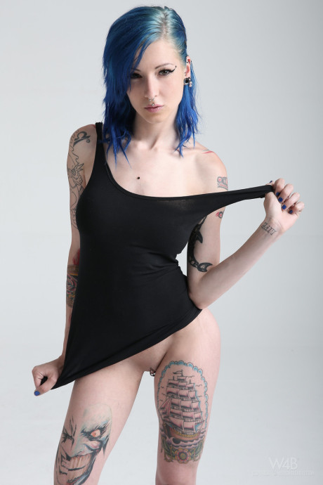 Teen with blue hair exposes her slender body, large tits and hot tattoos