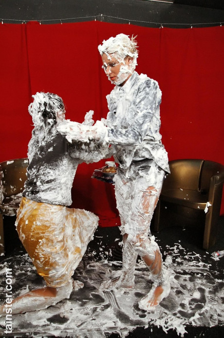 Fully clothed ladies completely cover each other in whipped cream