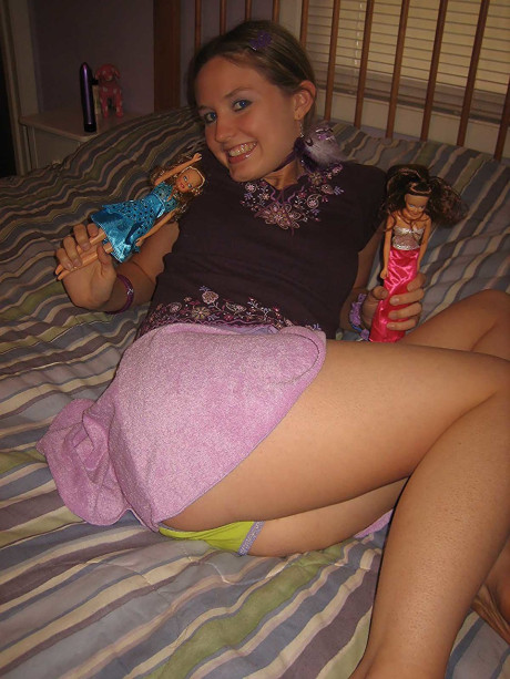 Sweet brunette Kitty strips and toys herself after playing with Barbies