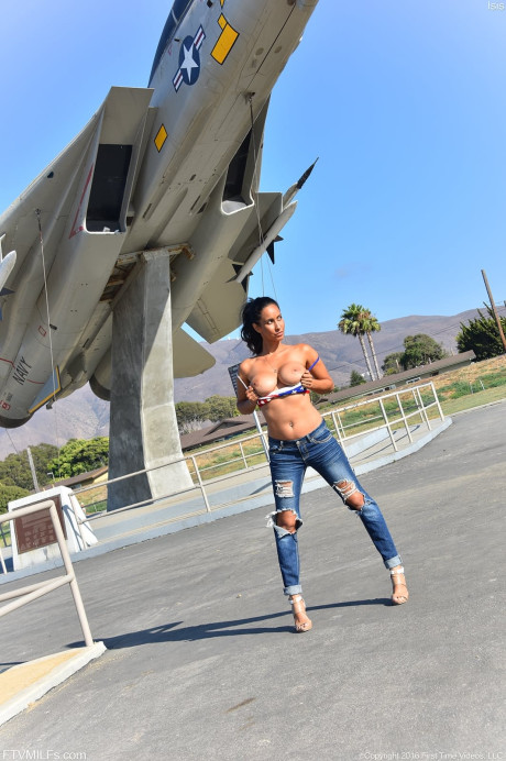 Latina MILF Isis Love masturbates before posing in ripped jeans