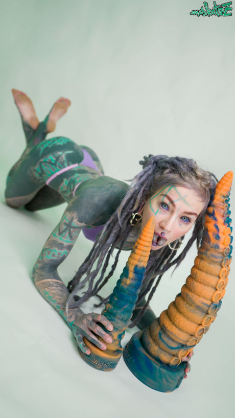 Heavily tattooed lady girlfriend broad Anuskatzz holds a lovers of taintacle toys in the naked