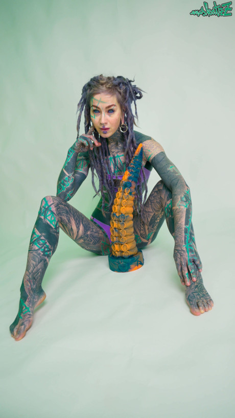 Heavily tattooed lady girlfriend broad Anuskatzz holds a lovers of taintacle toys in the naked