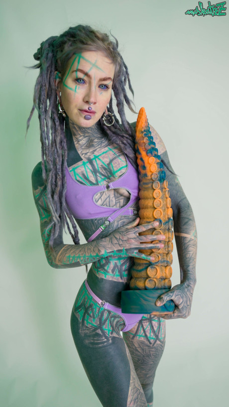 Heavily tattooed lady girlfriend broad Anuskatzz holds a lovers of taintacle toys in the naked