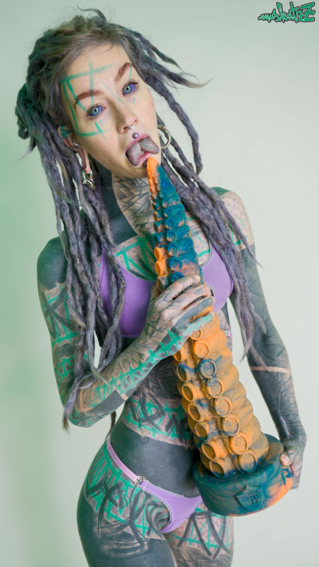 Heavily tattooed lady girlfriend broad Anuskatzz holds a lovers of taintacle toys in the naked