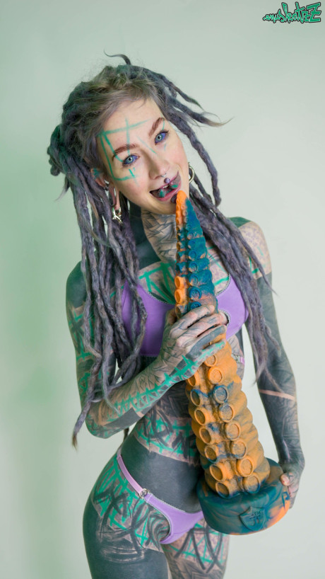 Heavily tattooed lady girlfriend broad Anuskatzz holds a lovers of taintacle toys in the naked