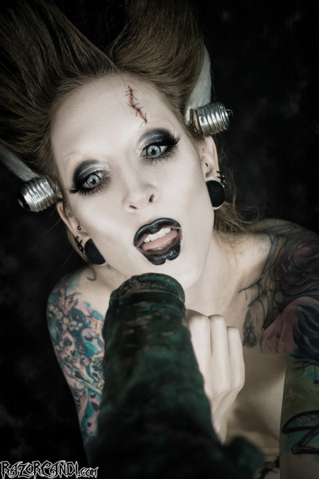Tattoo model Razor Candi blows on a massive dildo in Bride of Frankenstein attire