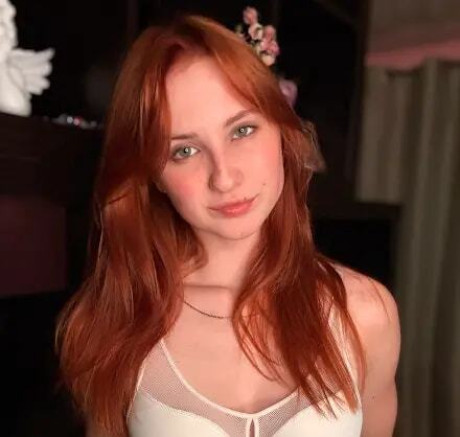 Redheaded amateur models white undergarment during a SFW photo shoot