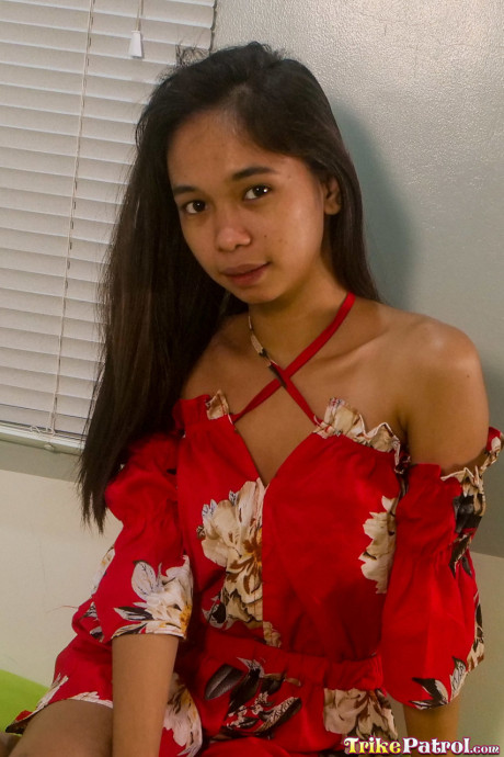 Pretty oriental teen Lexi Barrera doffs her clothes and poses behind undressed