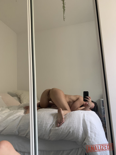 Amateur model holds her raw butt during a series of naked selfies