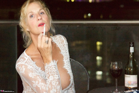 Mature blonde nasty Doctor smokes while showing her huge breasts and vagina