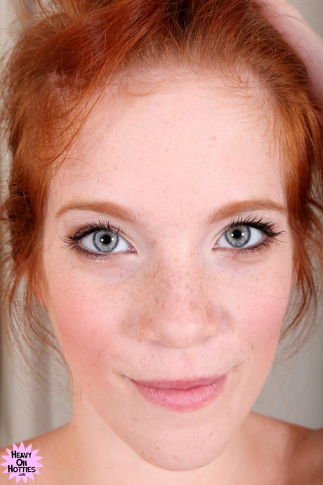 Lovely ginger head with freckles Roxy Rush reveals her body on a couch