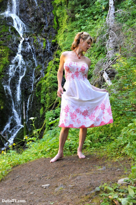 Stunning pretty Delia by waterfall erect under her dress