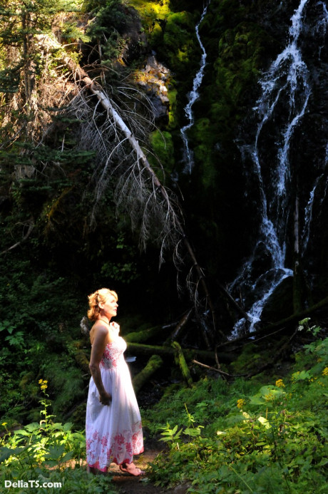 Stunning pretty Delia by waterfall erect under her dress
