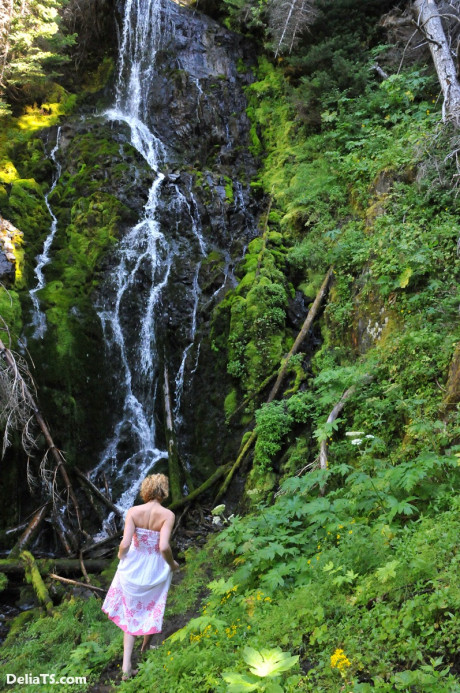 Stunning pretty Delia by waterfall erect under her dress