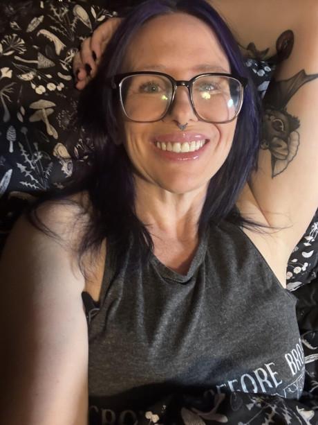 Tattooed amateur with purple hair and glasses takes selfies in the nude