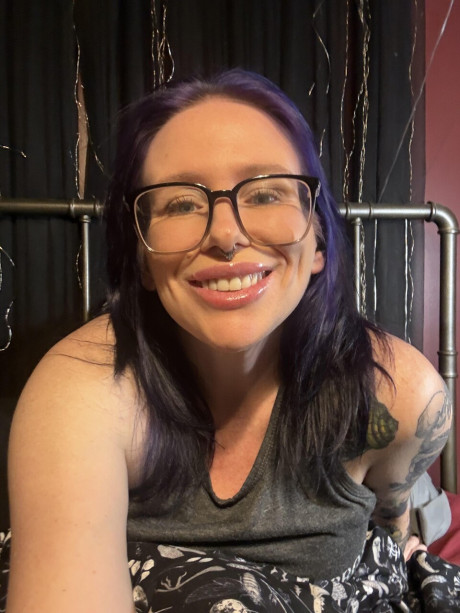 Tattooed amateur with purple hair and glasses takes selfies in the nude