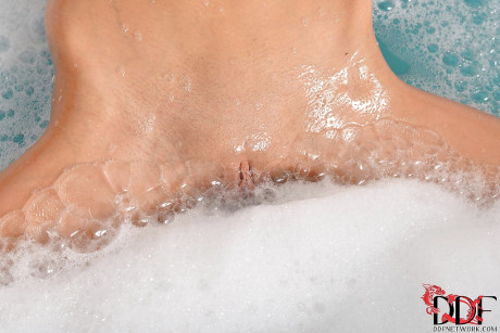 Petite european teen taking foamy bath and masturbating her tight vagina