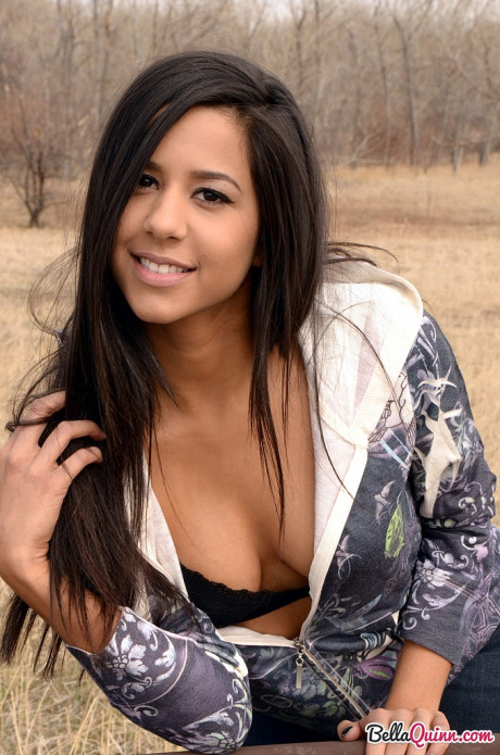 Amateur model Bella Quinn exposes ebony bra on an outdoor bench