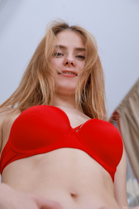 Hot teenie Dakota Pink removes red stockings to pose nude on a recliner
