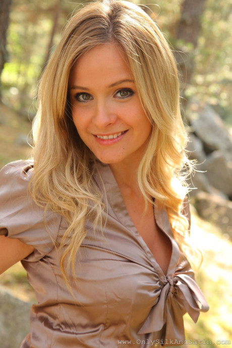 Foxy blondie Elle Richie teases with her breasts while stripping in the woods