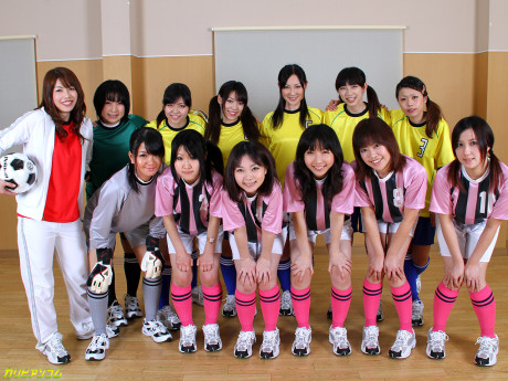 Chinese female football team watches as a teammate gets poked by the referees
