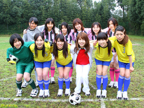 Chinese female football team watches as a teammate gets poked by the referees
