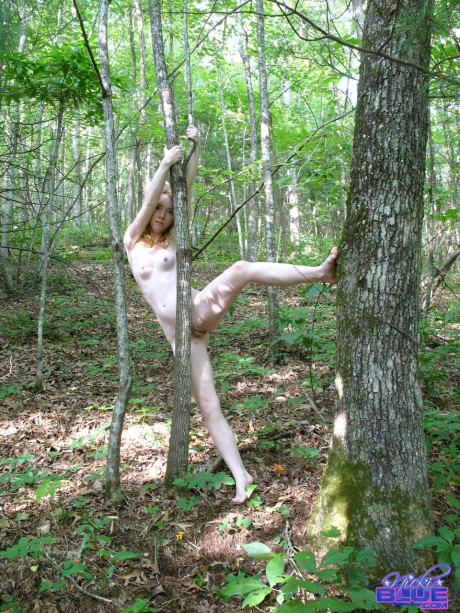 Sleazy yellow-haired Nicki Blue teasing nude with her petite body in the woods