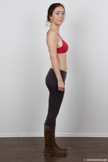 Tall female Jana stands nude after disrobing before taking a rocker
