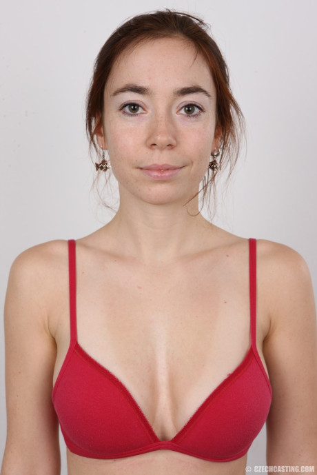 Tall female Jana stands nude after disrobing before taking a rocker