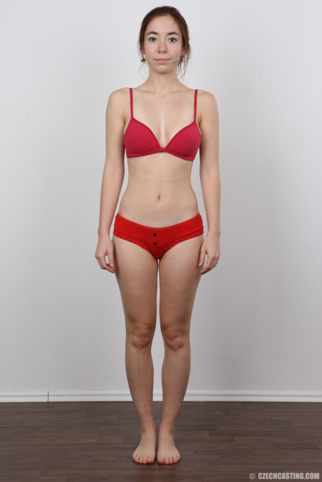 Tall female Jana stands nude after disrobing before taking a rocker