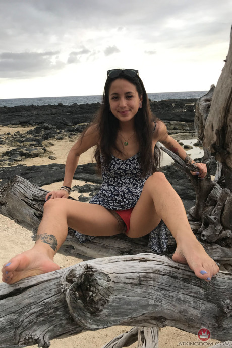 Teenie Mi Ha Doan flashes her tits and exposes her furry cunt on the beach
